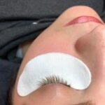 image of woman having her eyelashes tinted