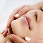 Woman massaging face