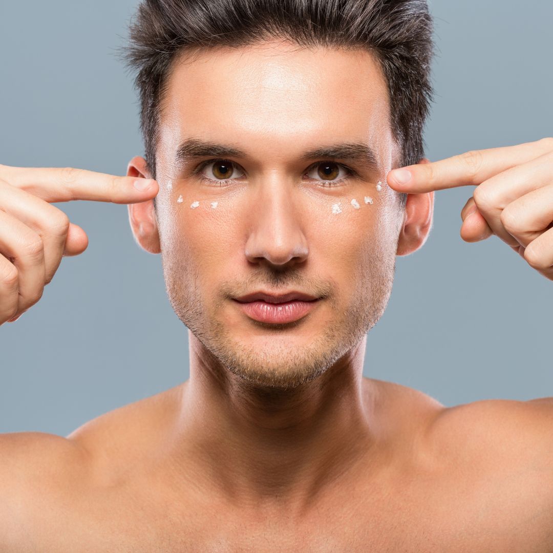 man with eye cream