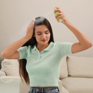 Young lady using dry shampoo