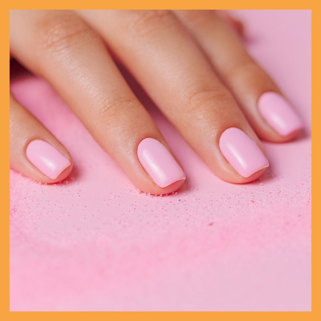 pink nails laying hand on towel