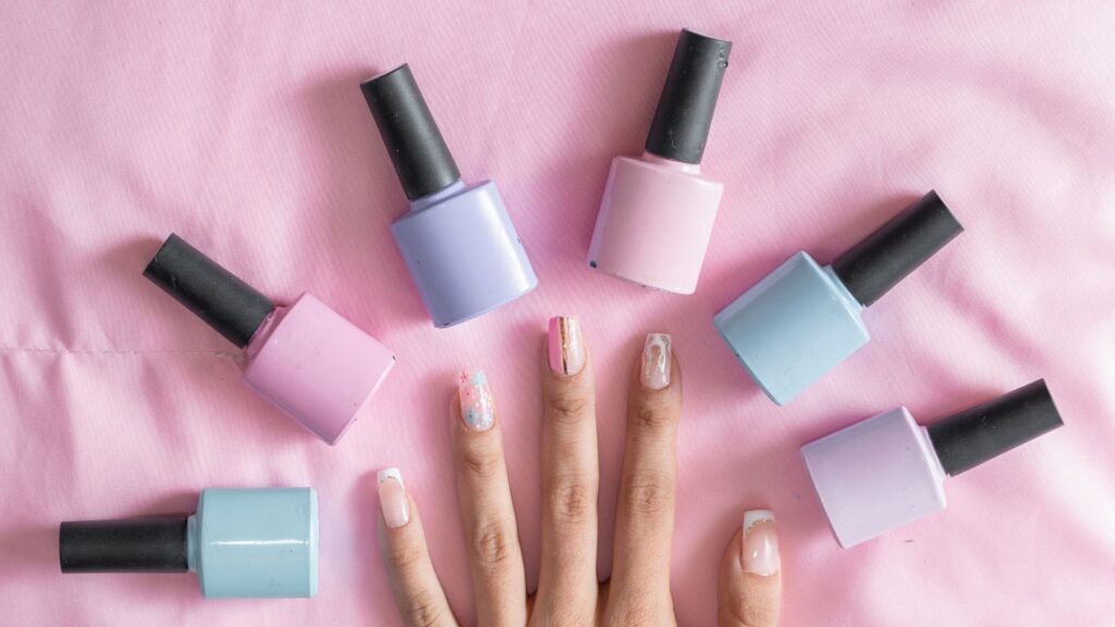 nail polish and a hand that have their nails done