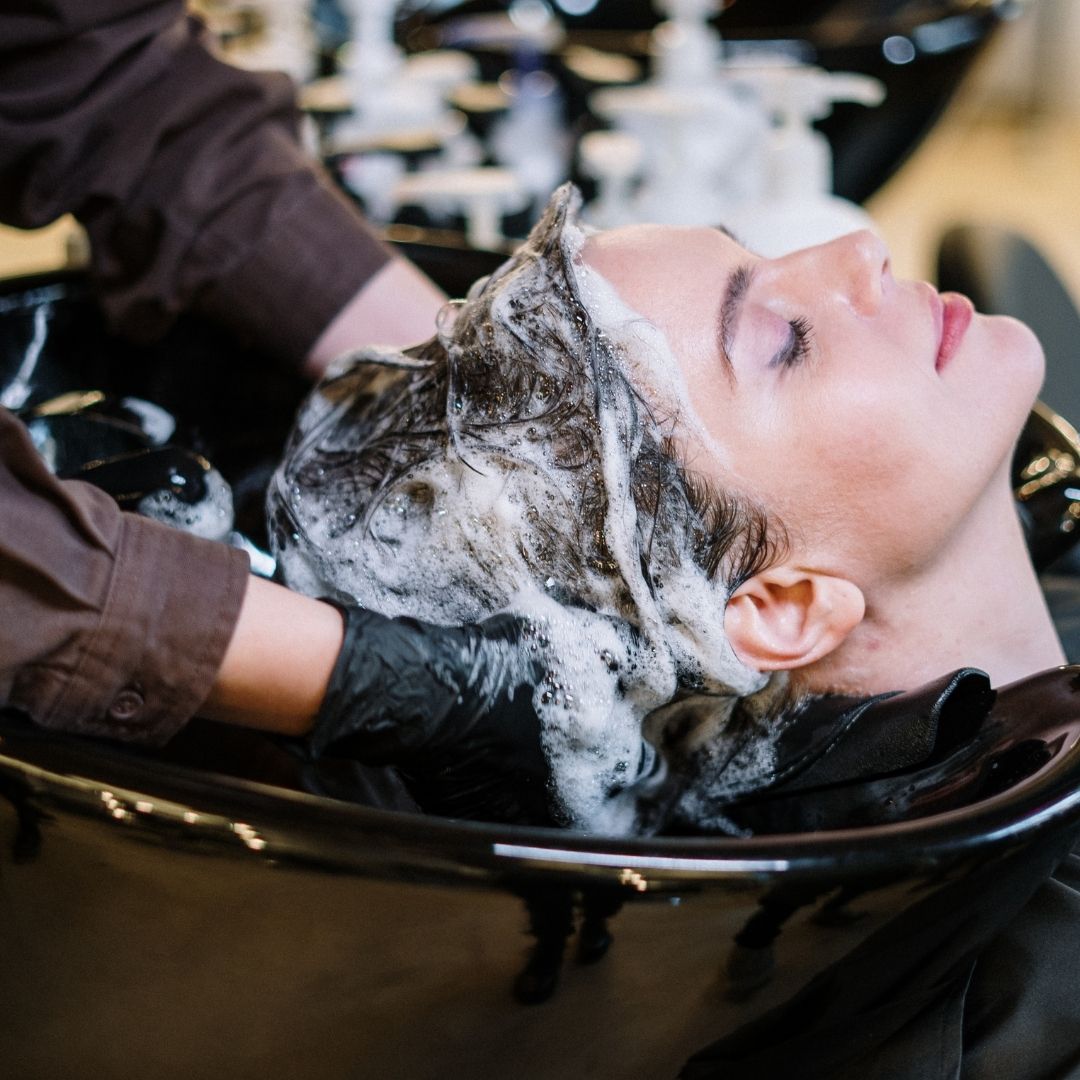 stylist adding in conditioner