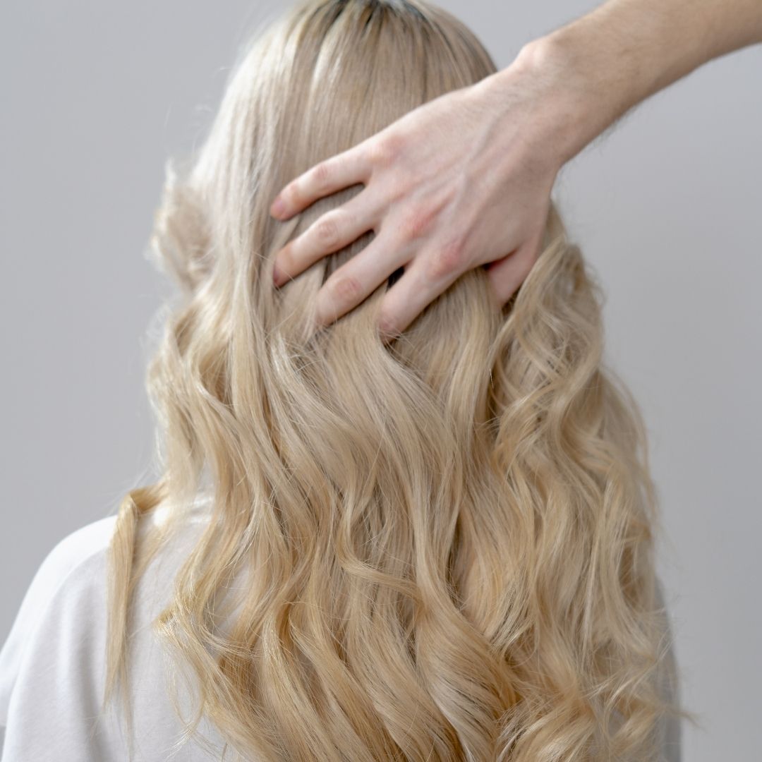running hand through hair at the scalp