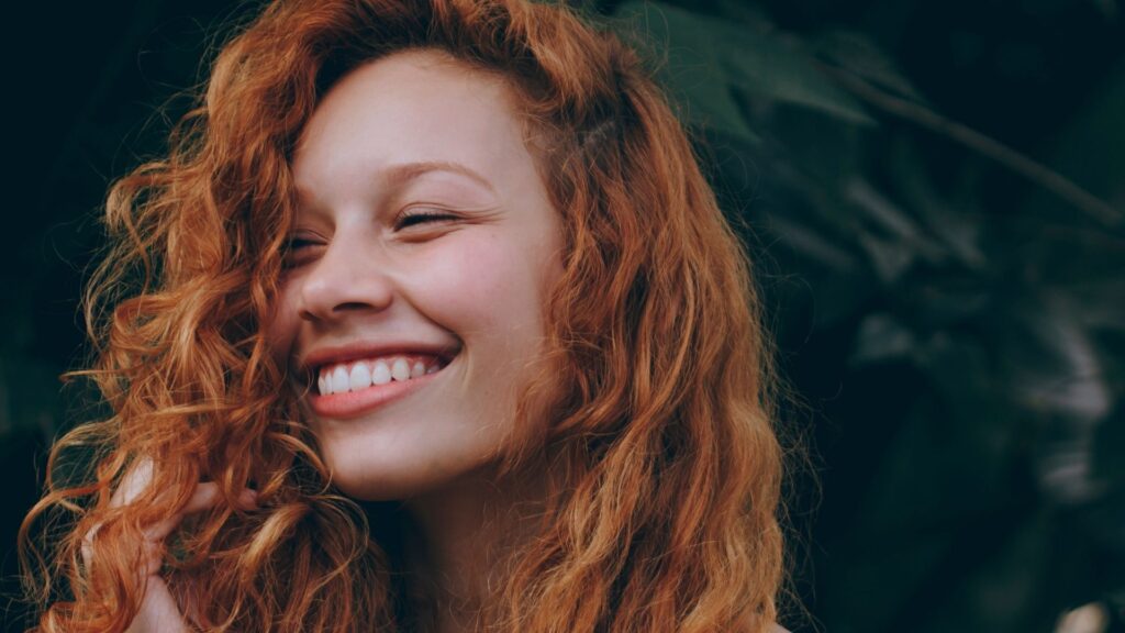 girl smiling with curly hair