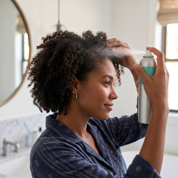 woman spraying hair